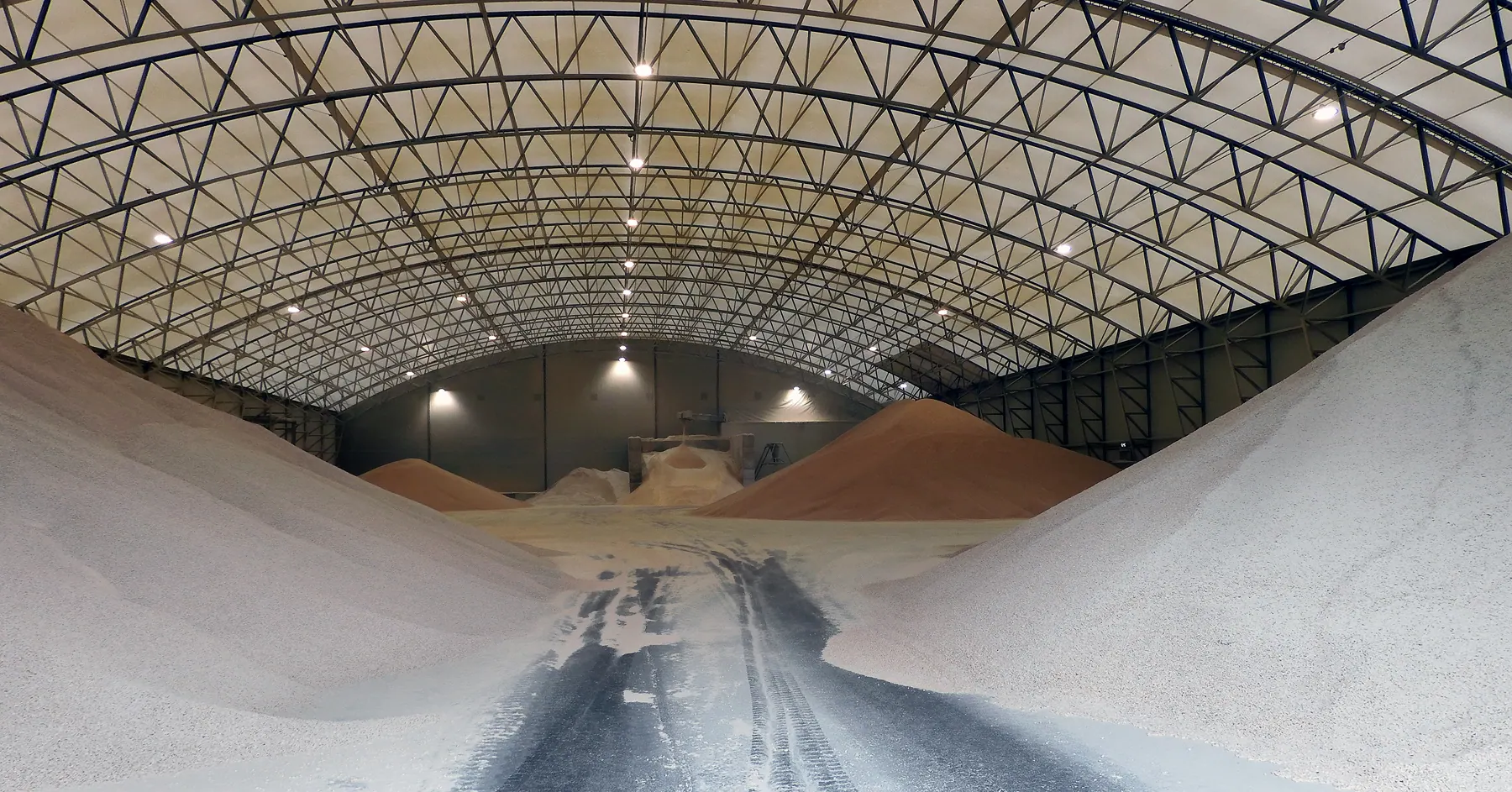 Bulk wood pellets stored in a large covered hall